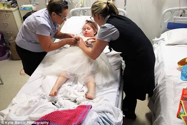 Terminally Ill Four-Year-Old Given A Week To Live Is Wheeled Down The Aisle As Flower Girl At Her Parents Wedding 
