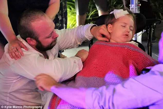 Terminally Ill Four-Year-Old Given A Week To Live Is Wheeled Down The Aisle As Flower Girl At Her Parents Wedding 