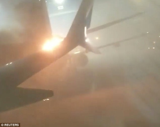 Passengers scream in terror as the plane next to them catches fire after crashing into them on the tarmac in Toronto