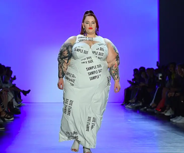 Tess Holliday Makes Statement In White Cut-Out Dress With The Words 'Sample Size' During NYFW